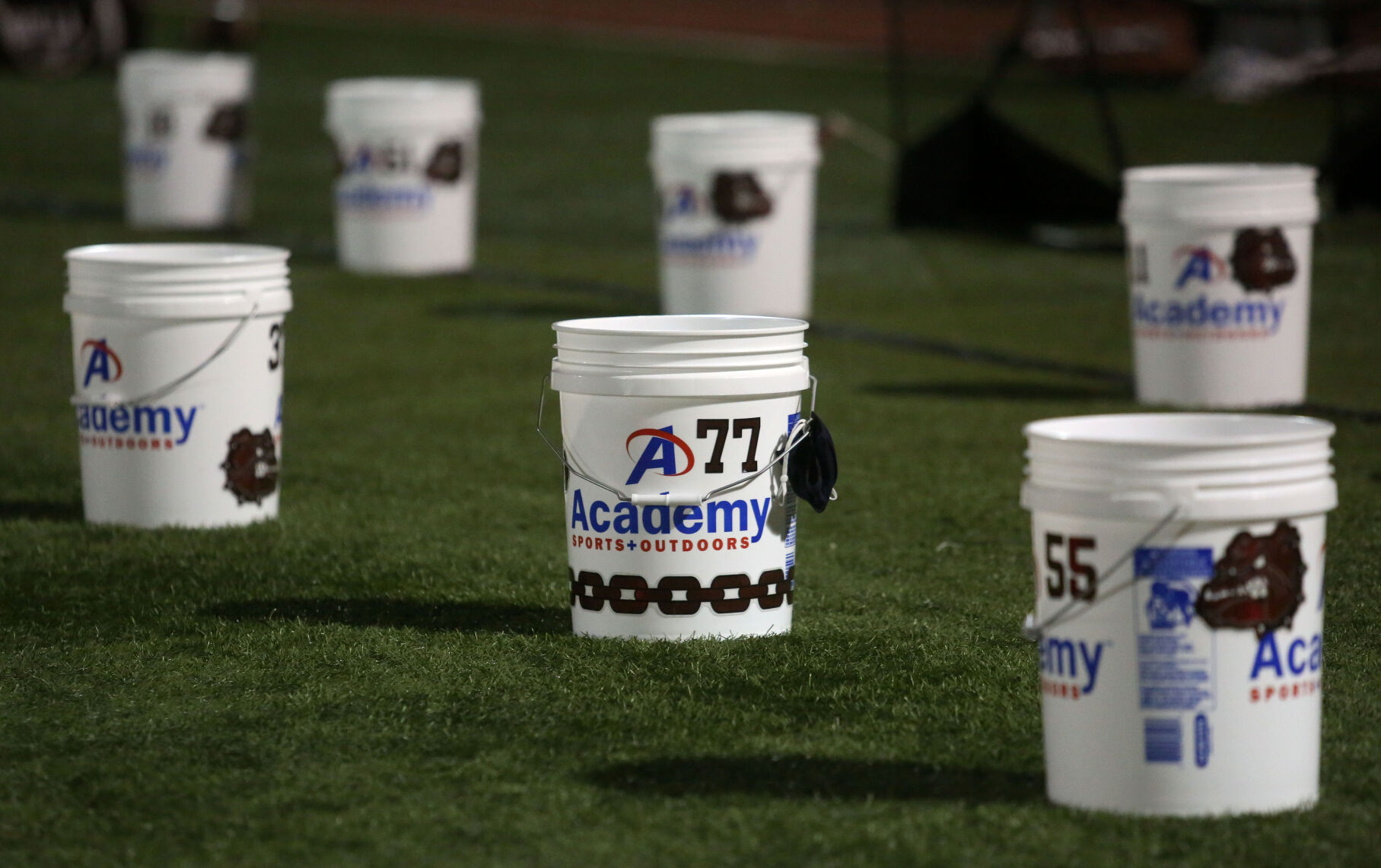 The Rolla Bulldogs football team places the belongings of each player in five-gallon buckets